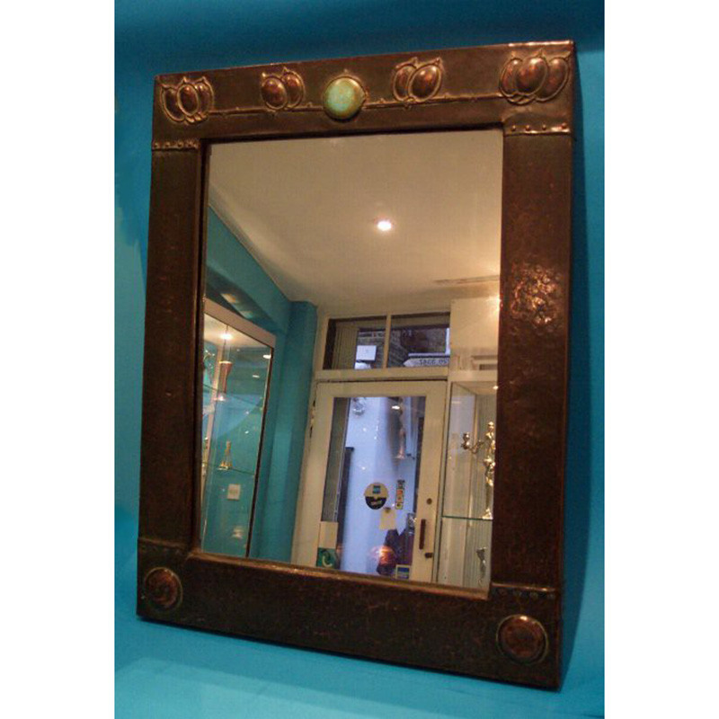 Possibly Archibald Knox design copper wall mirror with original glass plate (c.1903)